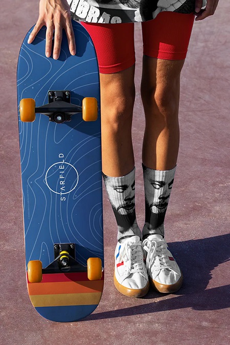 A photo of someone holding a Starfield-themed skateboard.