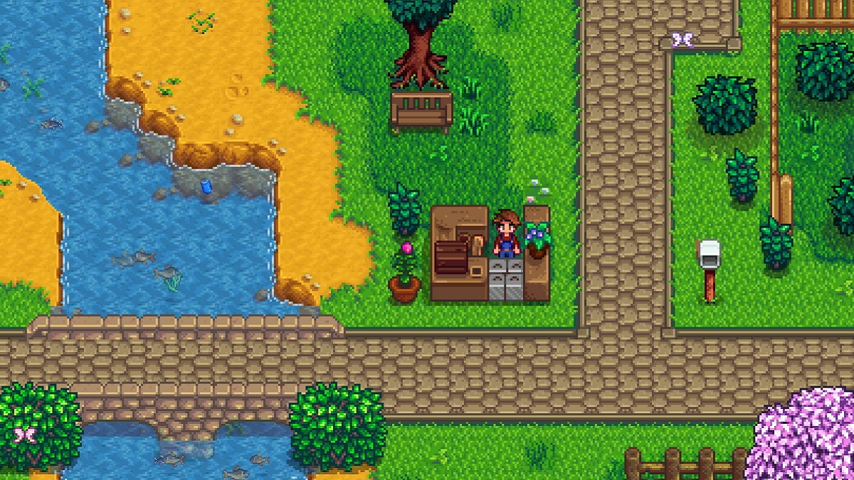 Stardew Valley: the player stood at an outdoor stall by the river.