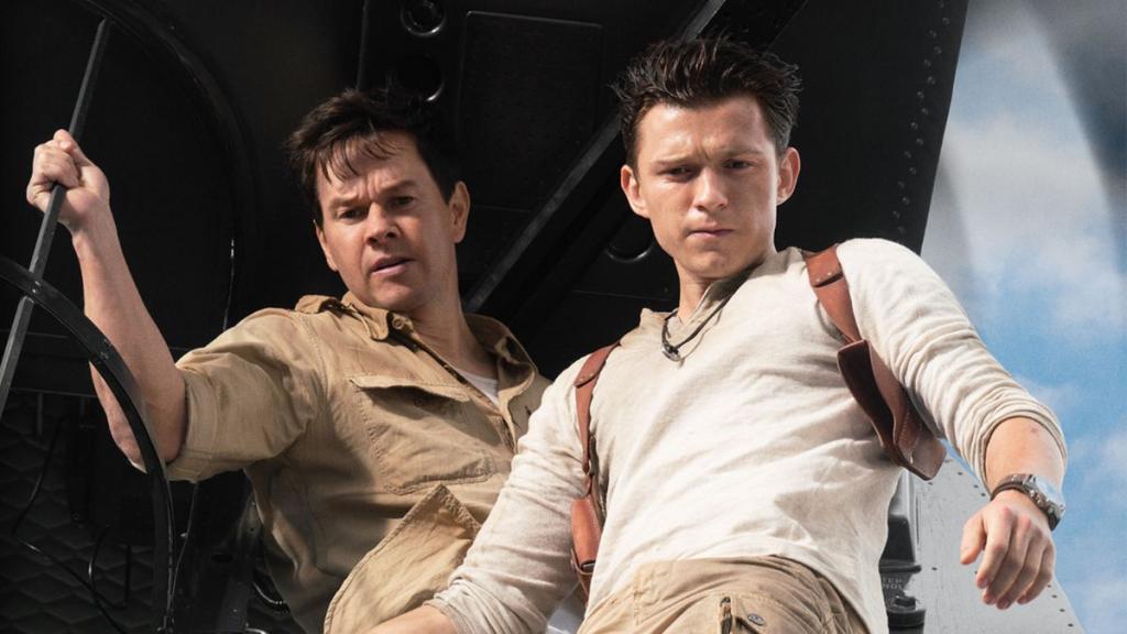 Mark Walhberg (left) and Tom Holland (right) as Sully and Nate looking down from plane in Uncharted movie