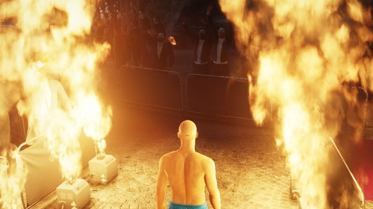 agent 47 with fire around him in hitman world of assassination the disruptor