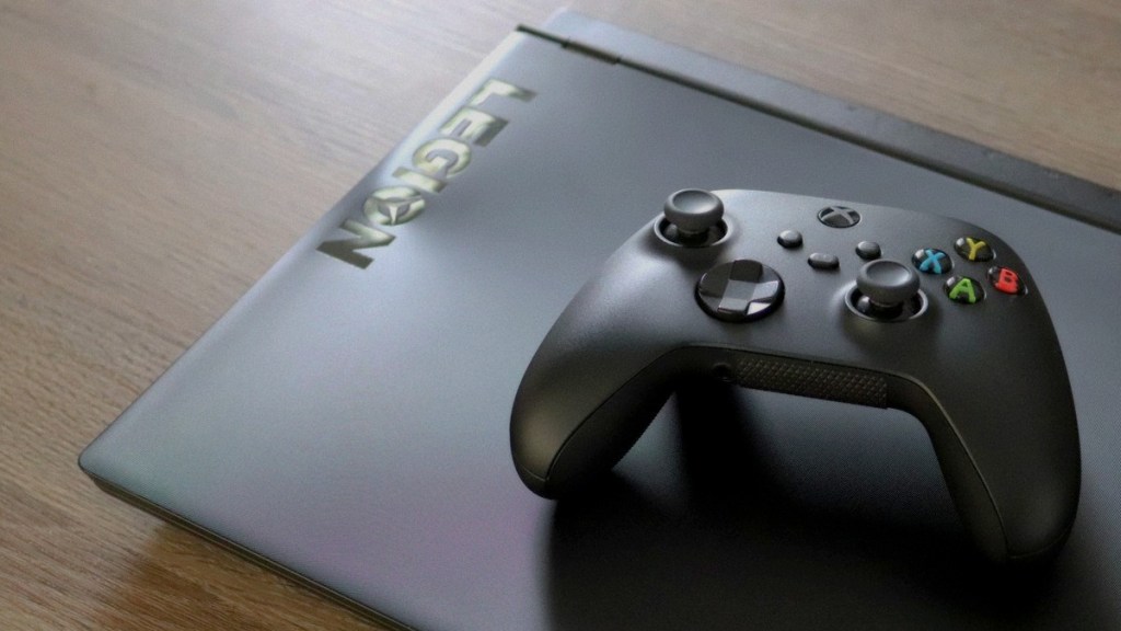 A picture of an Xbox Series controller on top of a Bazzite OS laptop.