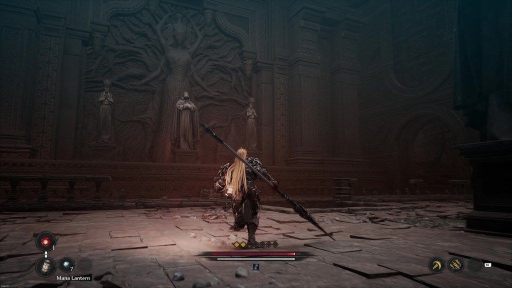 A set of statues in front of a bas relief