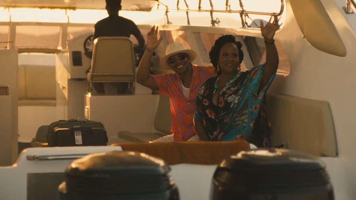 a man and a woman on a boat, waving