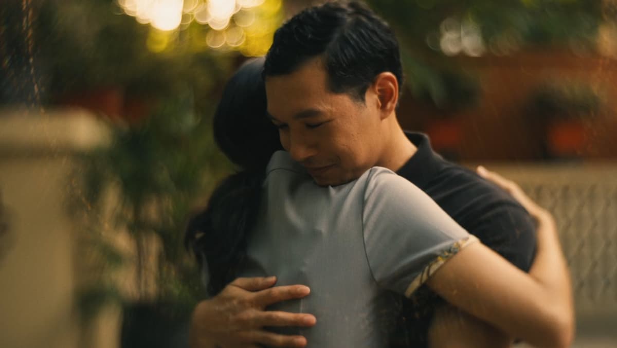 a man hugging a woman outside the hotel in white lotus season 3