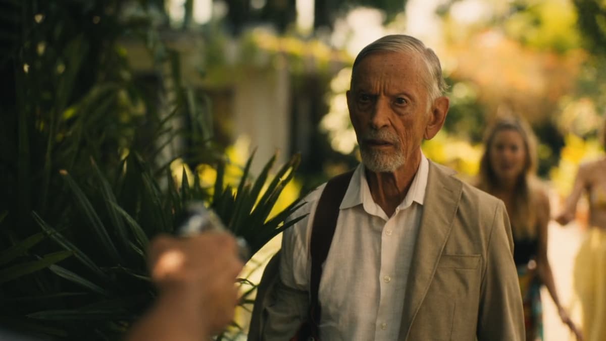 a still of an old man beind held at gunpoint in white lotus season 3