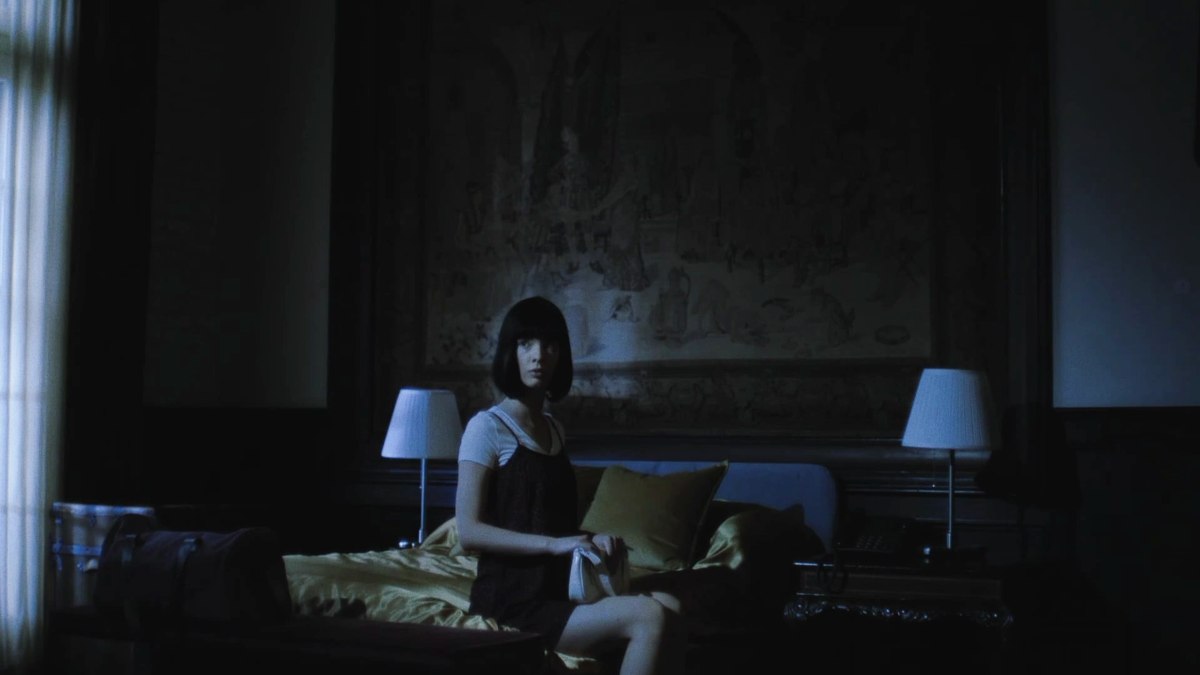 Marissa Marcel starring in Two of Everything, sitting on a bed looking outwards