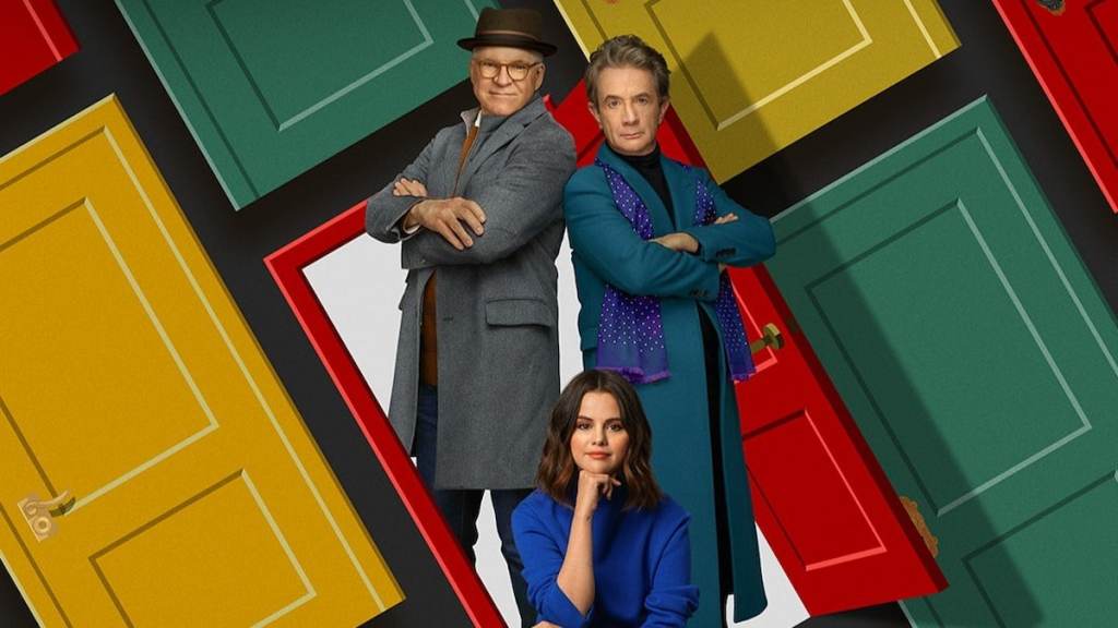 Charles and Oliver standing back to back and Mabel sitting in front of them in front of colorful yellow, green, and red doors in only murders in the building