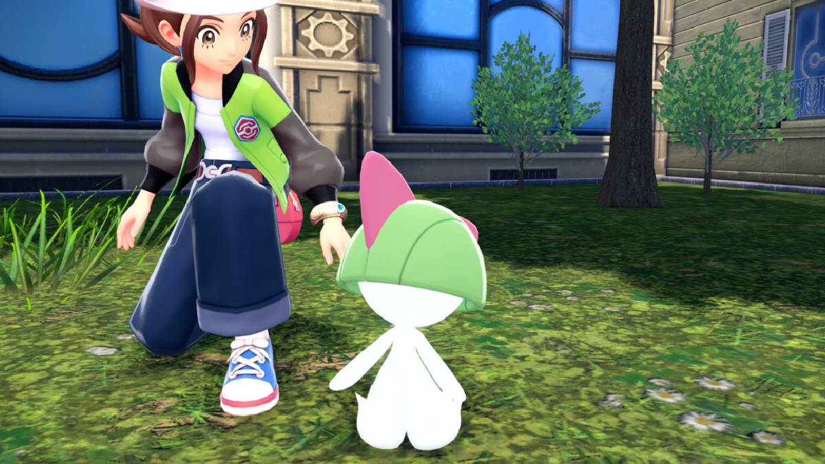 A trainer crouches next to a Ralts in Pokémon Legends Z-A