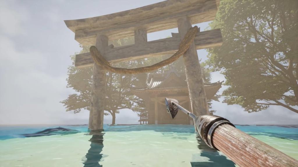 Looking at a torii gate with a shrine behind it on a small sandy island