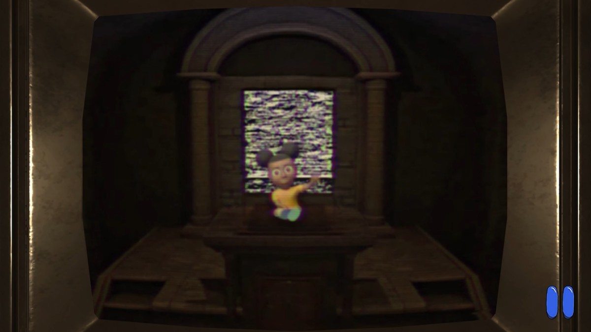 Amanda sitting on the Chapel podium, waving towards us as a static door opens behind her