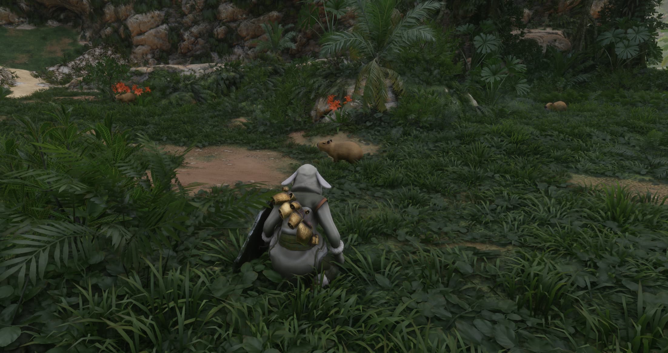 The player character in Enshrouded crouches in front of a Capybara.