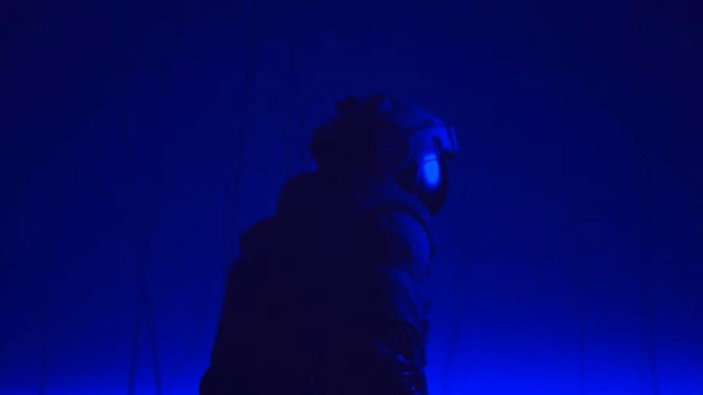 Shot of the engineer's back, looking over his shoulder towards the camera