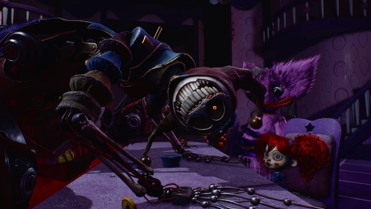 Prototype hanging his head, looking directly at camera, with Poppy and Kissy Missy seated opposite him