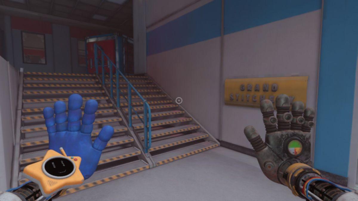 At bottom of stairs next to Grand Stitchery