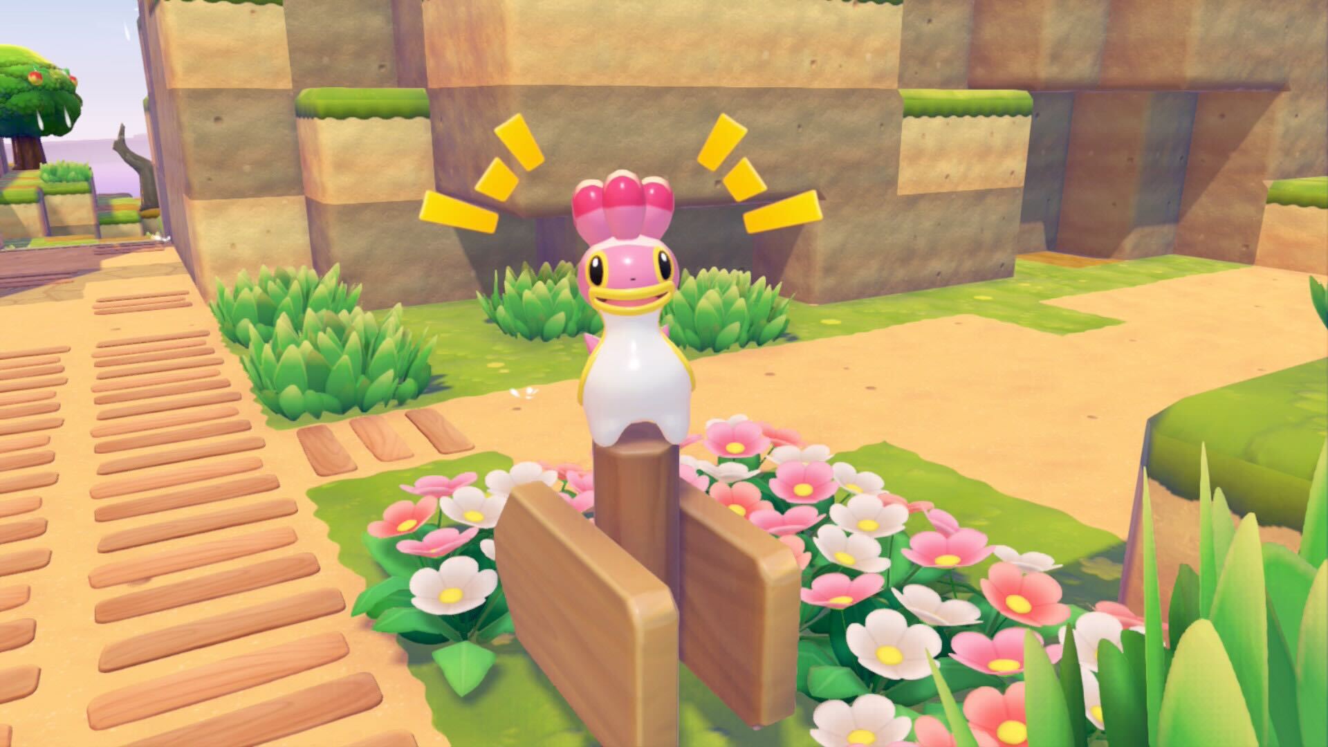A pink Shellos sits on a signpost with a happy expression on its face.