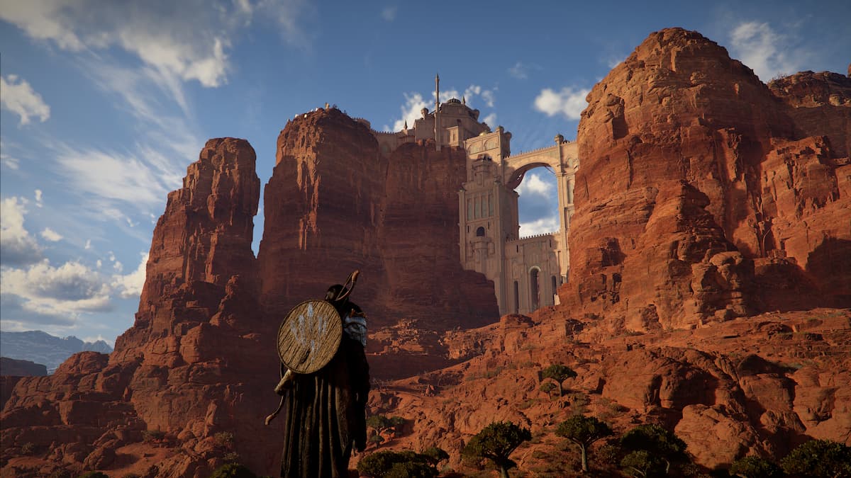 A temple built into the rock formations of a red desert in Crimson Desert.
